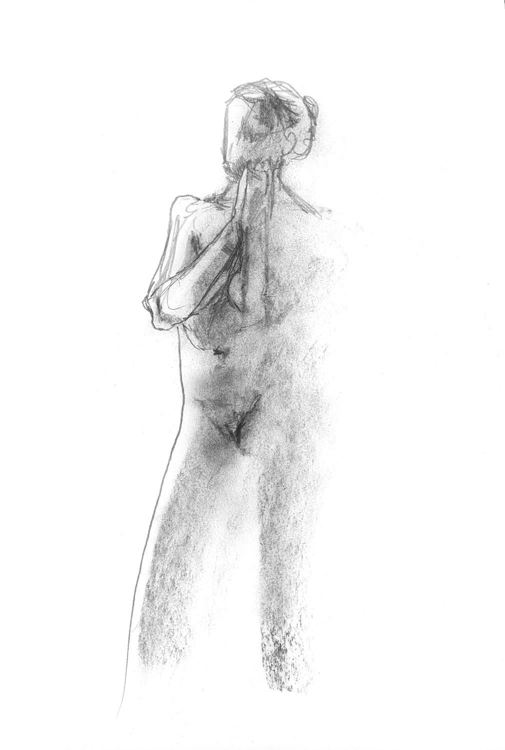 Female model standing with hands together.